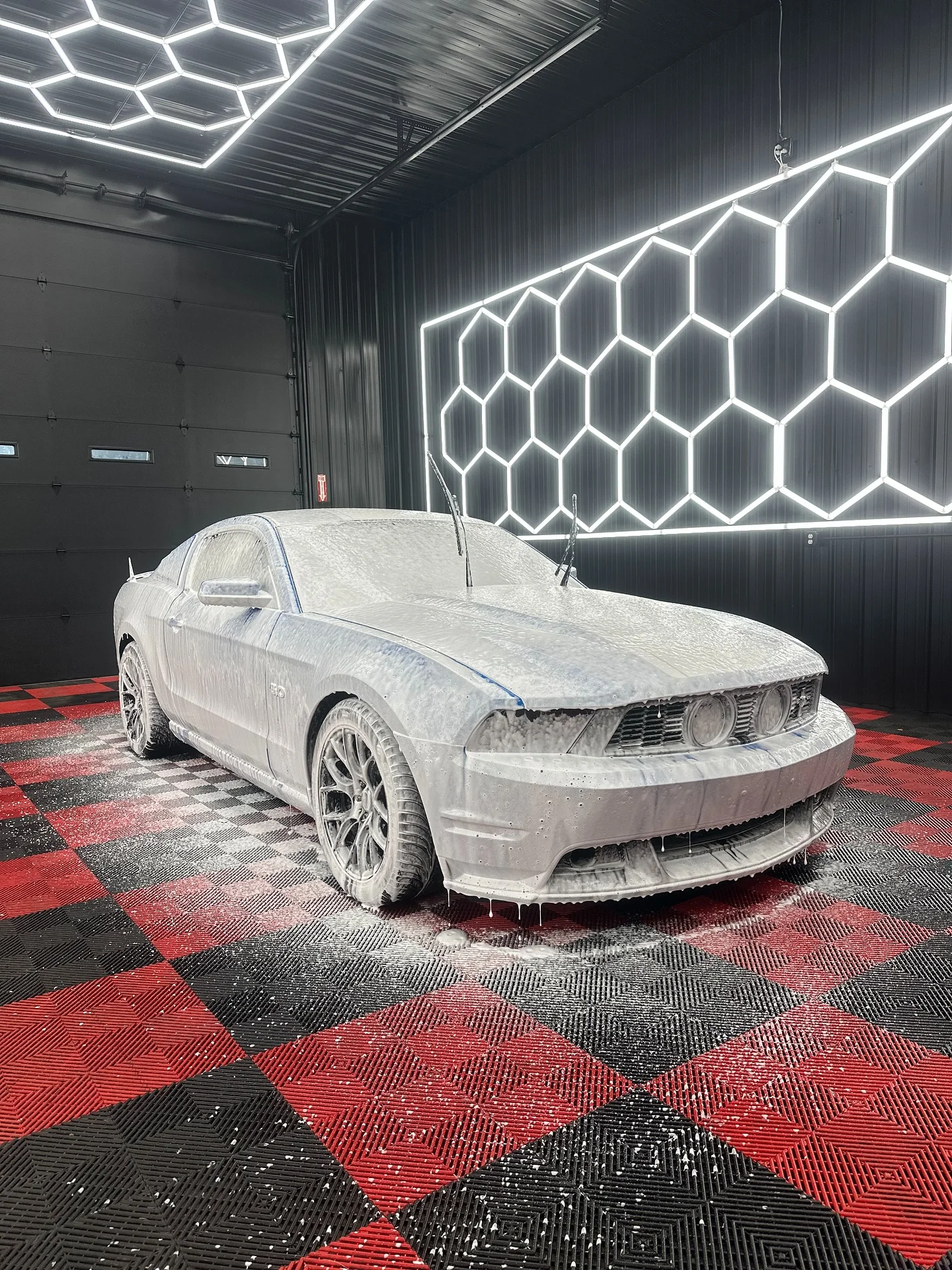 White Mustang before paint correction showing swirl marks Buffalo NY